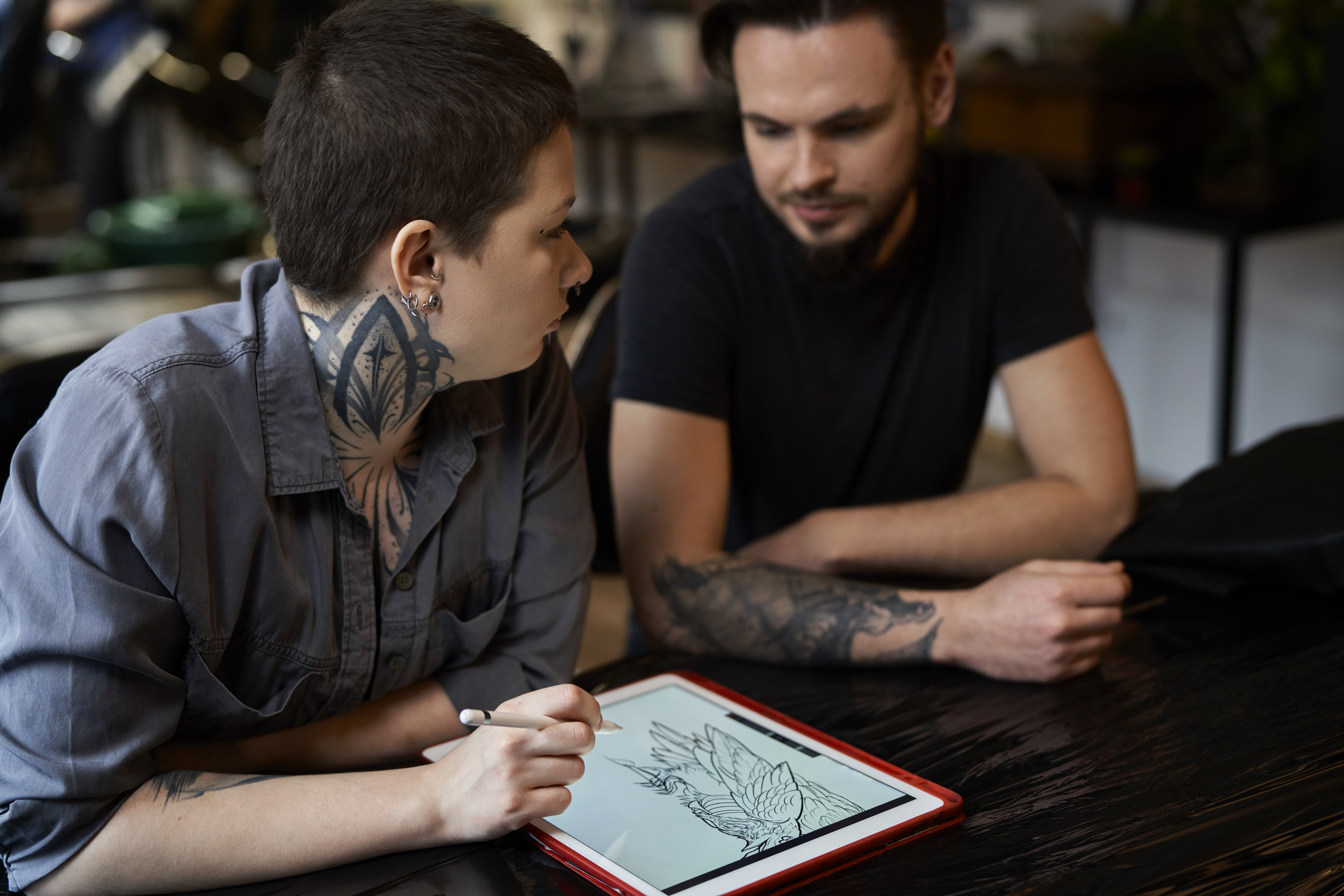 Close up of people talking about new tattoo