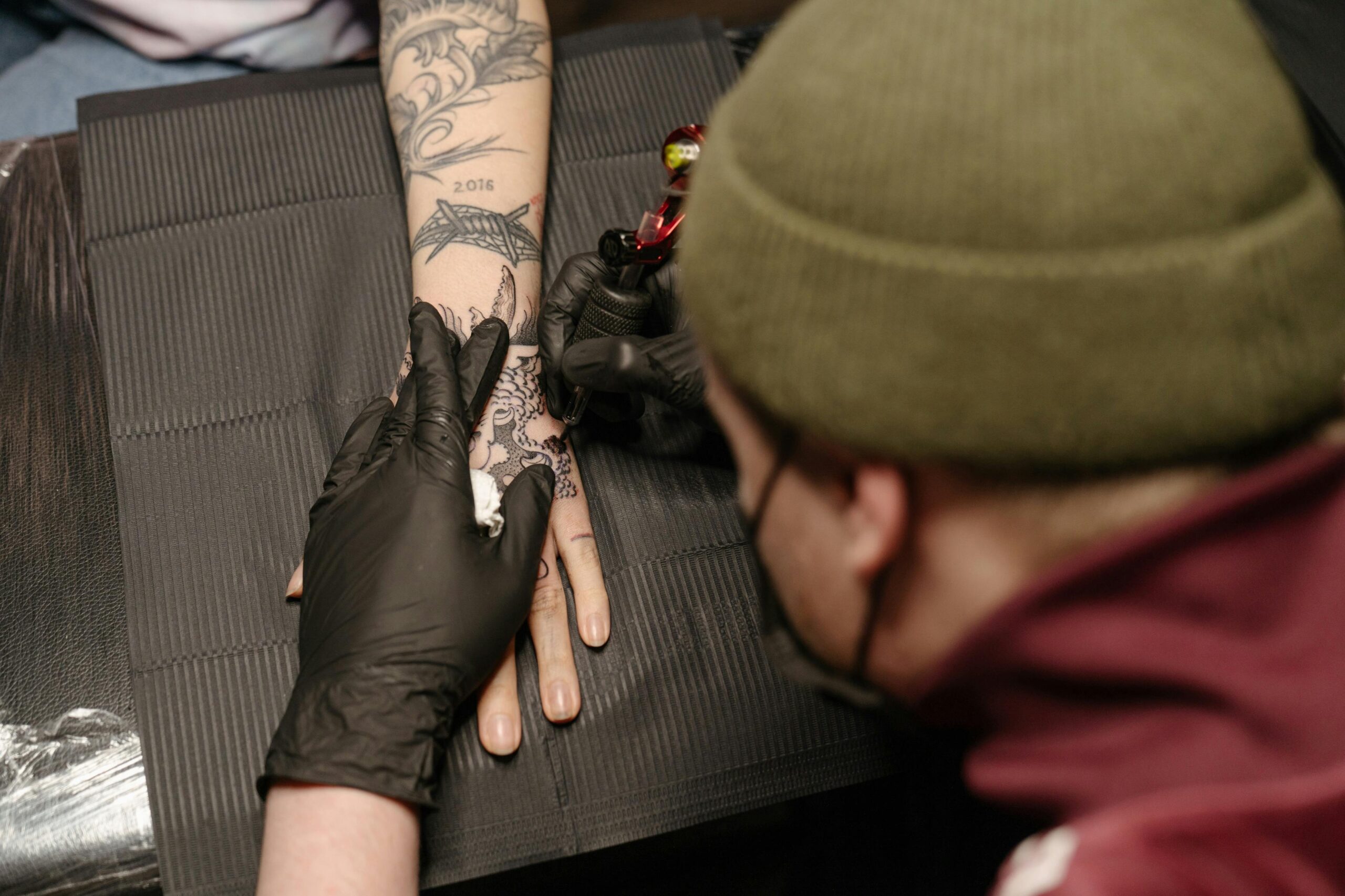 Tattoo artist doing tattooing
